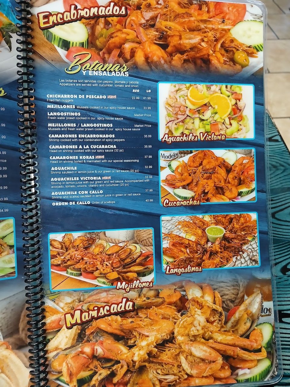 Printed seafood menu with tacos and empanadas.